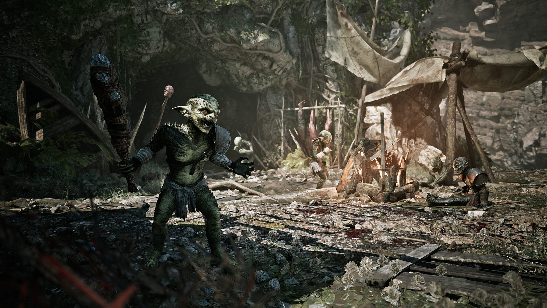 Several armed humanoid creatures gathered around a rough camp